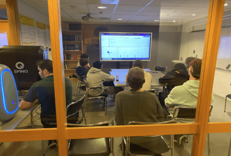 Students using an educational quantum computer to study quantum computing in a classroom.